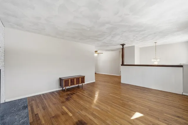 a view of a room with wooden floor