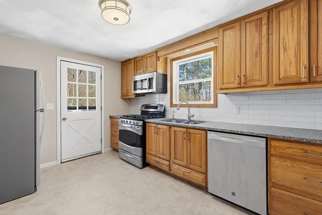 a kitchen with granite countertop a stove and a sink