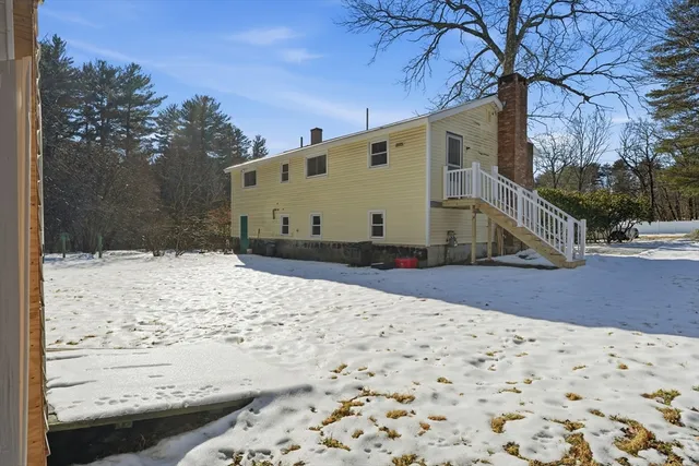 a view of a house with a snow in the yard