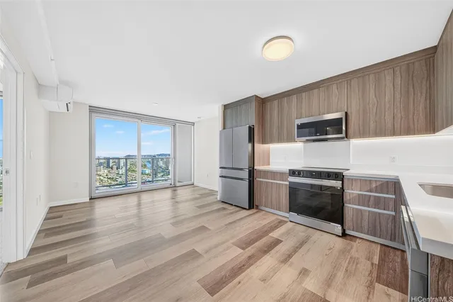 a kitchen with granite countertop a stove top oven a sink and a microwave