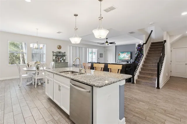 a living room with furniture and flowers