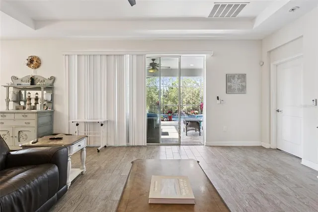a bed sitting in a spacious bedroom next to a window