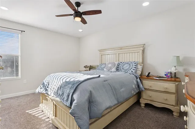 a bathroom with a granite countertop toilet sink and mirror