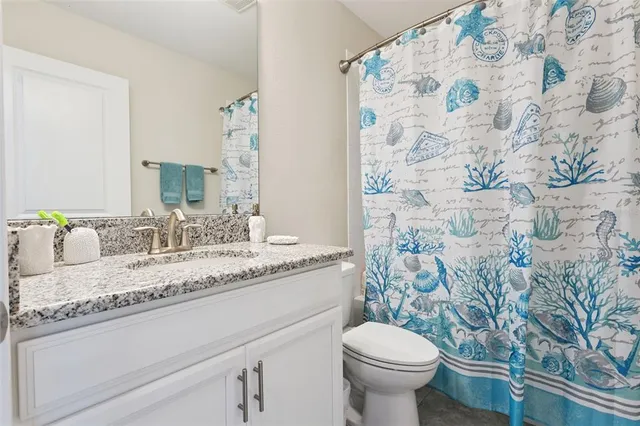 a living room with patio furniture and a floor to ceiling window