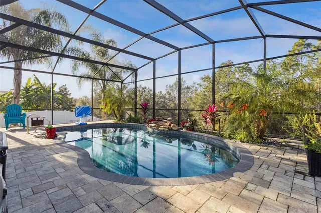 a view of a house with a yard and a fountain