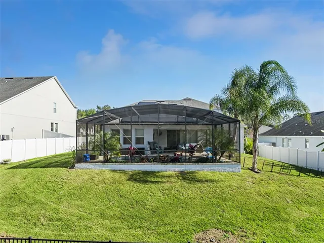 an aerial view of a house with a garden and lake view