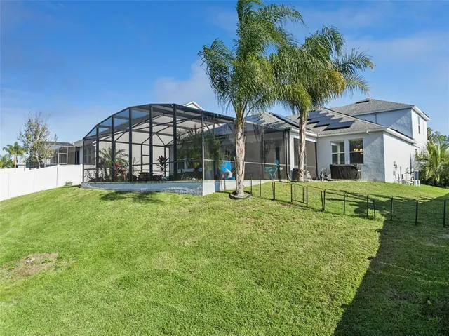 an aerial view of a house with a garden and lake view