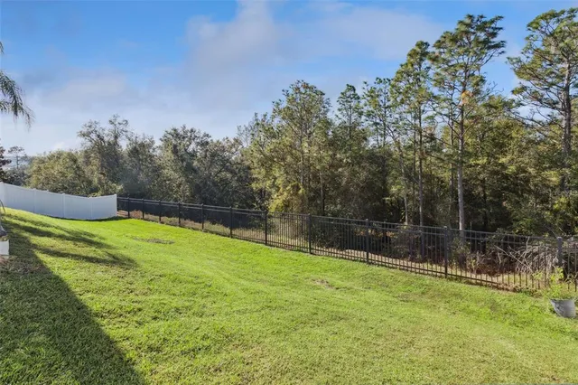 an aerial view of residential houses with outdoor space and street view
