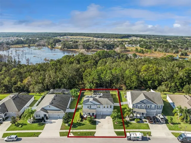an aerial view of residential houses with outdoor space and street view