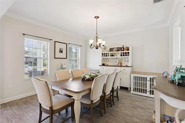 a kitchen with granite countertop a sink stainless steel appliances white cabinets and wooden floor