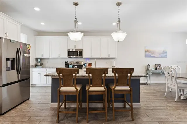 a living room with furniture a flat screen tv and a window