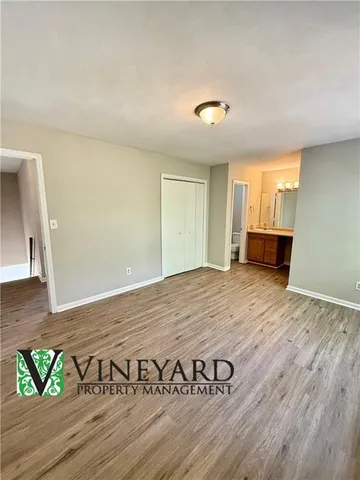 a view of a room with wooden floor and a window