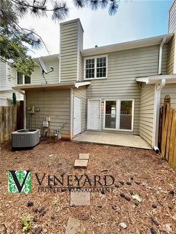 a backyard of a house with table and chairs
