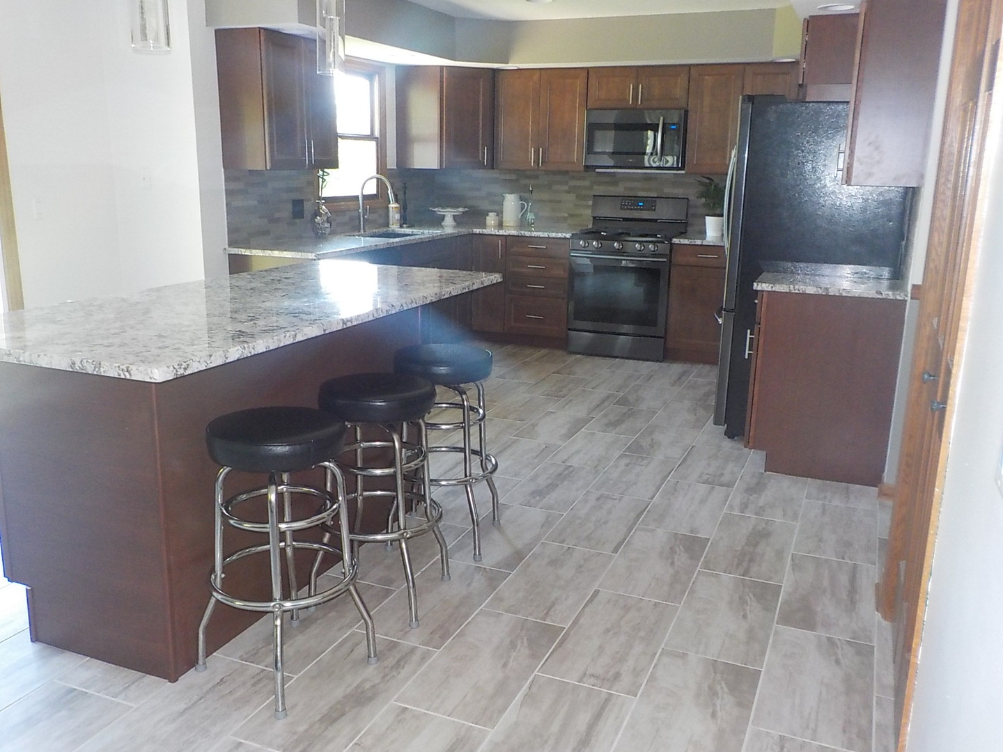 10144 Branch Road Rochelle, IL 61068 - Photo 3 of 38 a kitchen with granite countertop stainless steel appliances a sink and counter space