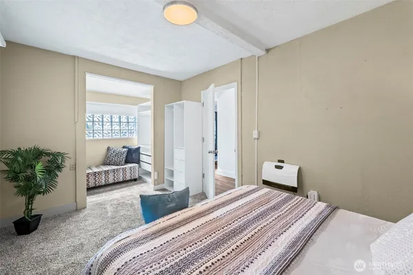 a bedroom with a bed and a potted plant