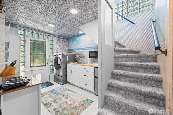 a view of kitchen with furniture and staircase