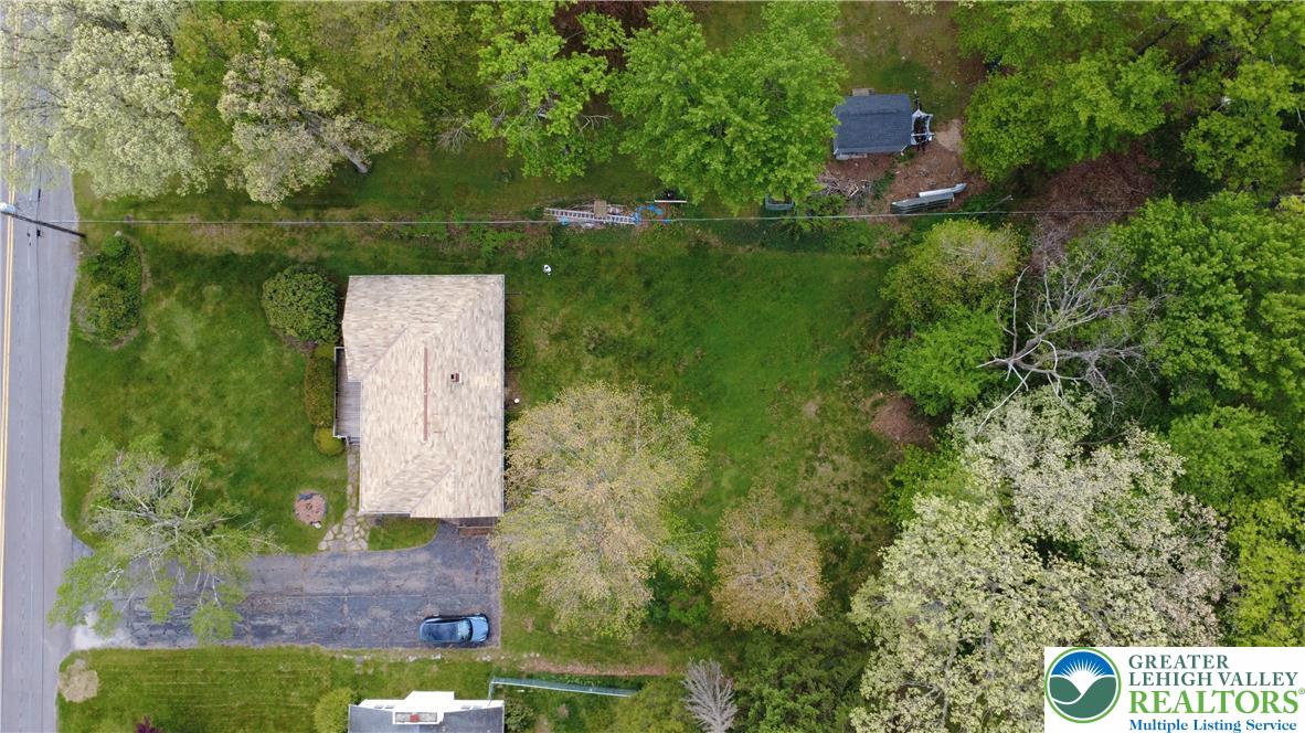 50 Montovision Road Mount Pocono, PA 18344 - Photo 30 of 32 An aerial perspective reveals a charming dwelling nestled amidst mature trees and verdant lawns.