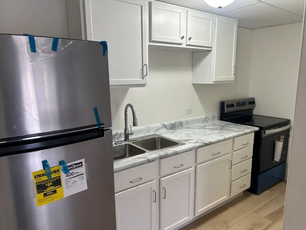 a kitchen with stainless steel appliances granite countertop a refrigerator and a sink