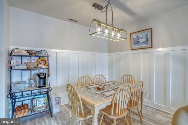 a view of a dining room with furniture wooden floor and a chandelier