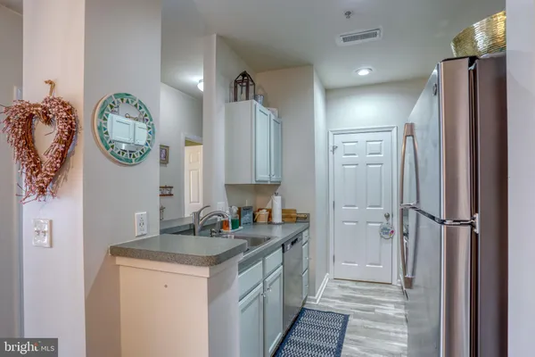 a kitchen with a refrigerator and a sink