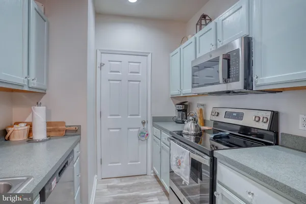 a kitchen with stainless steel appliances granite countertop a stove a microwave and a refrigerator