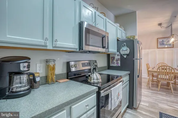 a kitchen with stainless steel appliances granite countertop a stove and a microwave