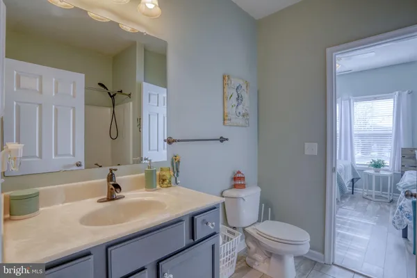 a bathroom with a sink toilet vanity and shower