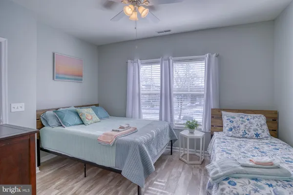 a bedroom with a large bed and a chandelier