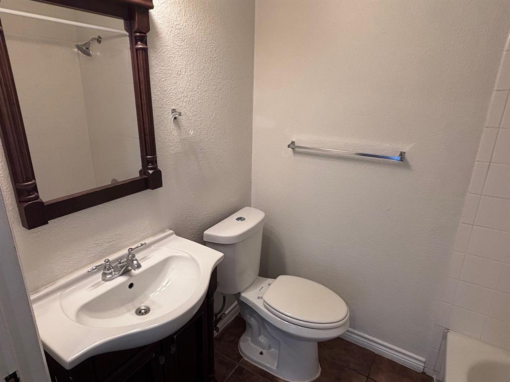 5003 Bryan Street, Unit 8 Dallas, TX 75206 - Photo 13 of 13 a bathroom with a sink a toilet and a mirror