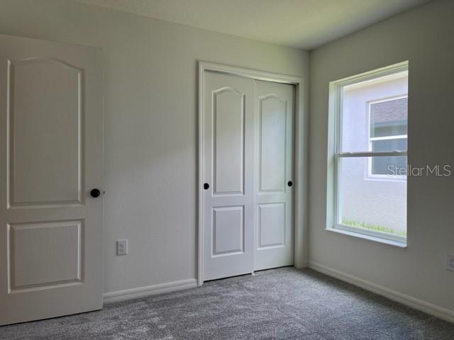 2792 Mdw Strm Way Clermont, FL 34714 - Photo 13 of 20 a view of an empty room with closet and a window