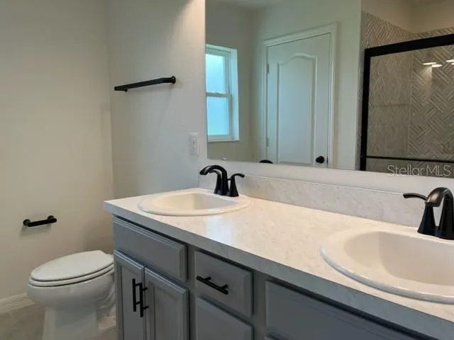 a bathroom with a sink a toilet and mirror