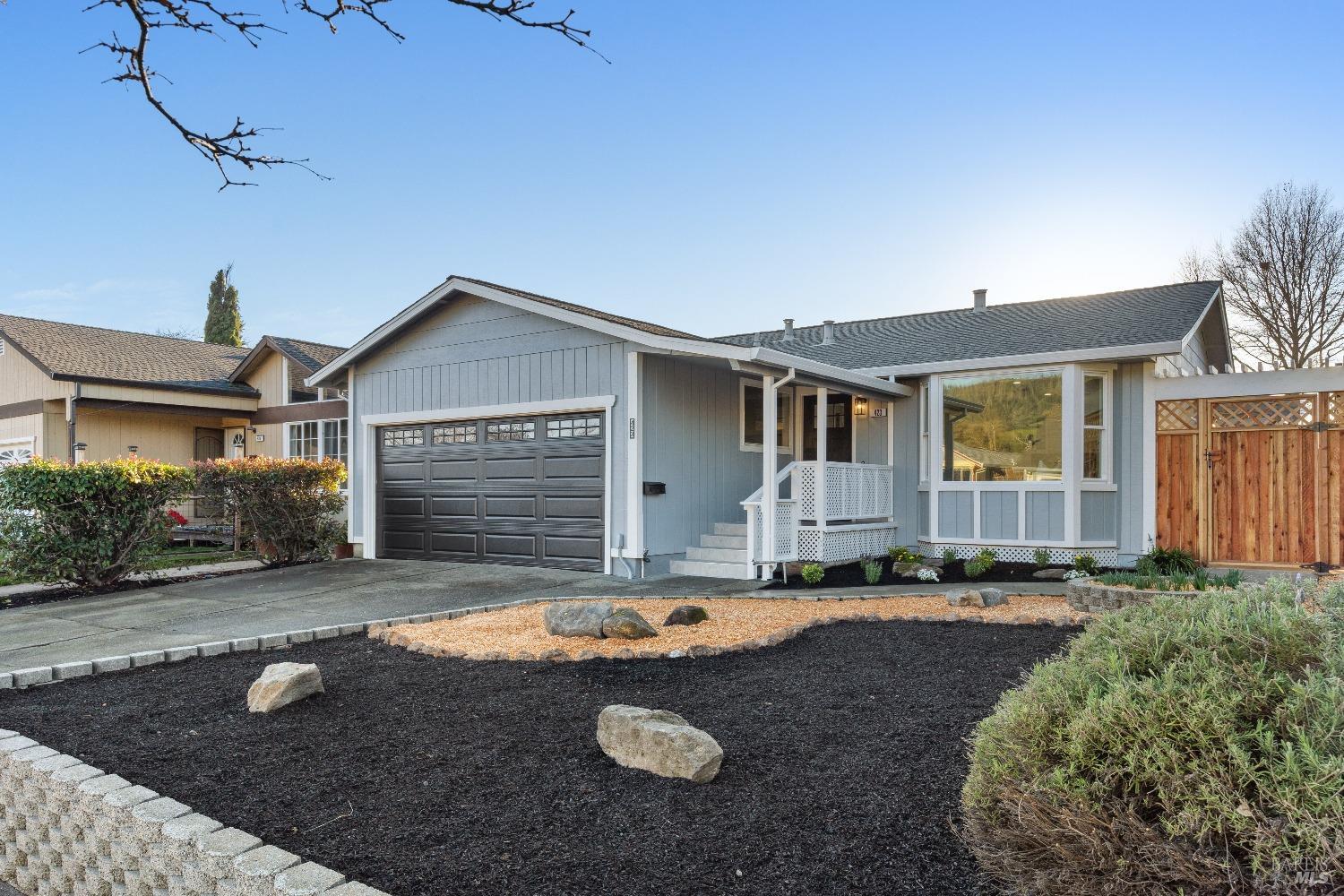 a view of a house with backyard and sitting area
