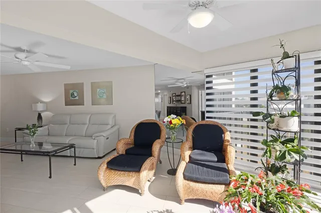 a living room with furniture and a painting on the wall