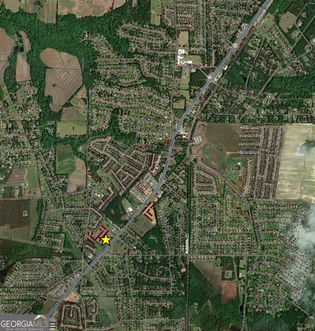 an aerial view of a residential houses with outdoor space