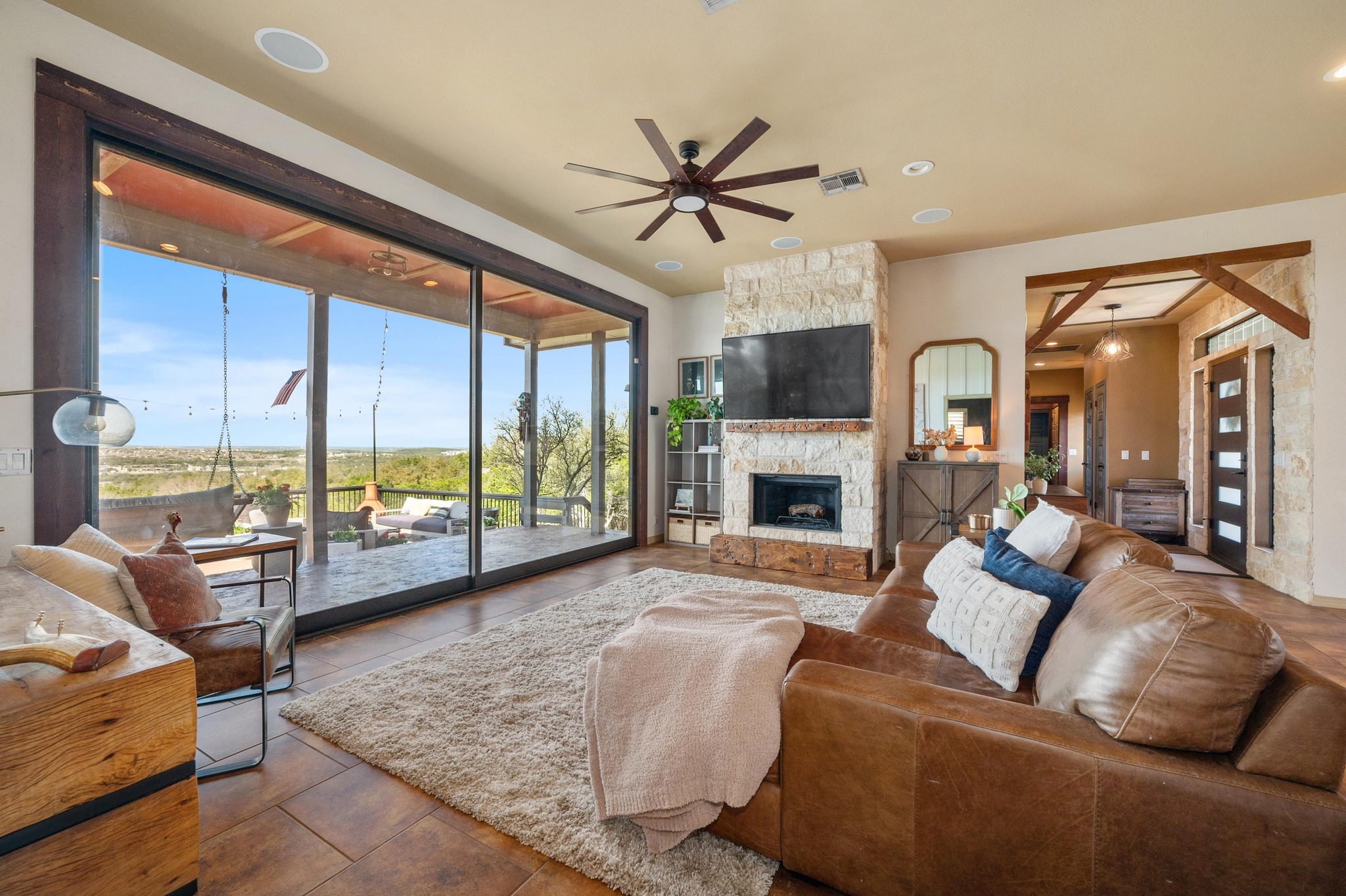 a living room with furniture fireplace and a large window