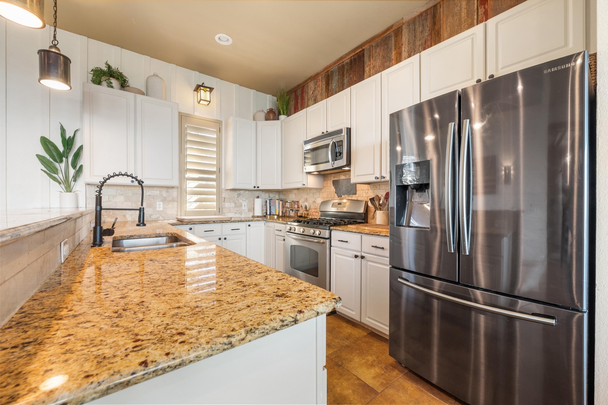 13602 Couri Pass Austin, TX 78738 - Photo 16 of 36 a kitchen with kitchen island a counter appliances a sink and cabinets