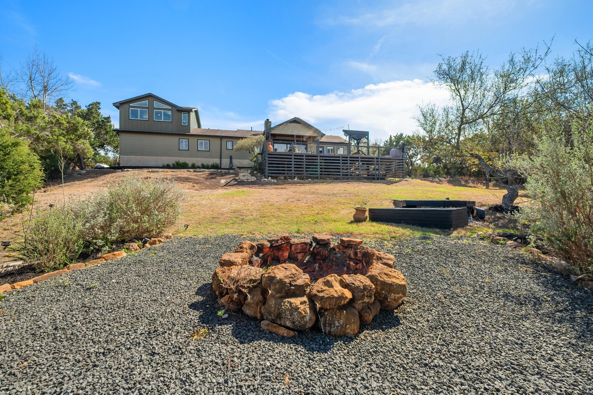 13602 Couri Pass Austin, TX 78738 - Photo 31 of 36 a front view of a house with a garden and lake view