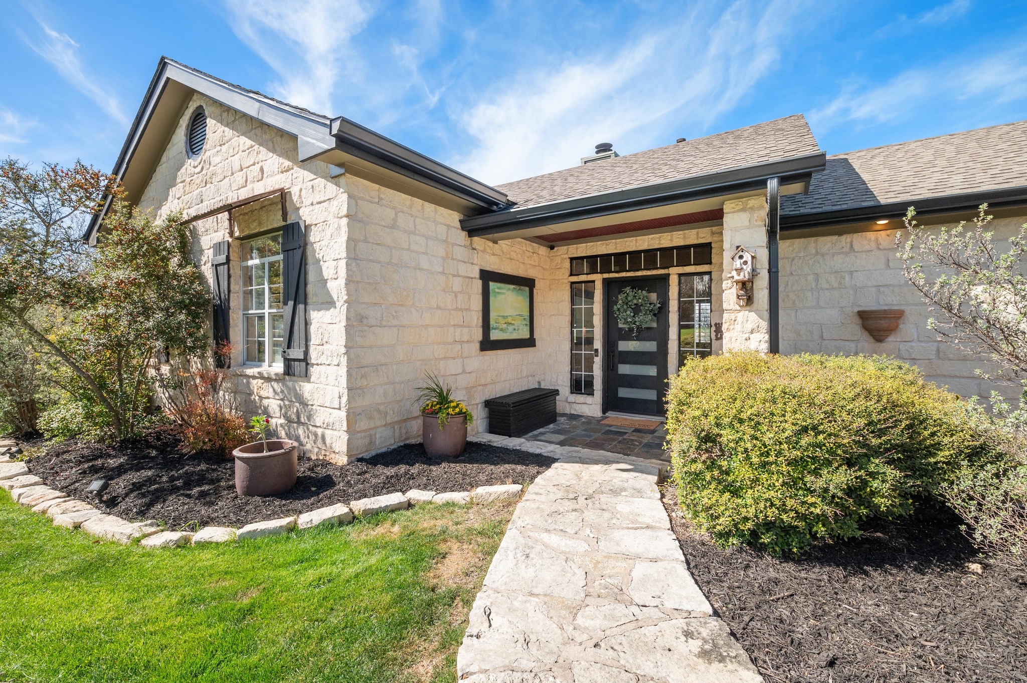 13602 Couri Pass Austin, TX 78738 - Photo 7 of 36 a front view of a house with garden