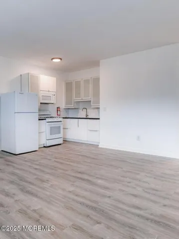 a view of kitchen with wooden floor and window