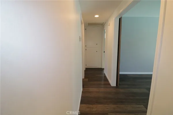 a view of a hallway with wooden floor