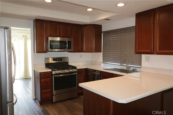 a kitchen with a sink a stove and refrigerator