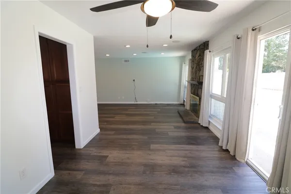 a view of a hallway with wooden floor and chandelier