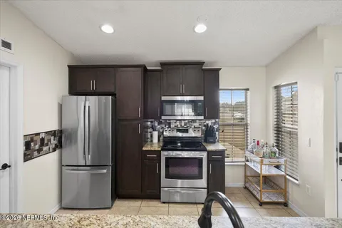 a kitchen with a refrigerator stove and microwave