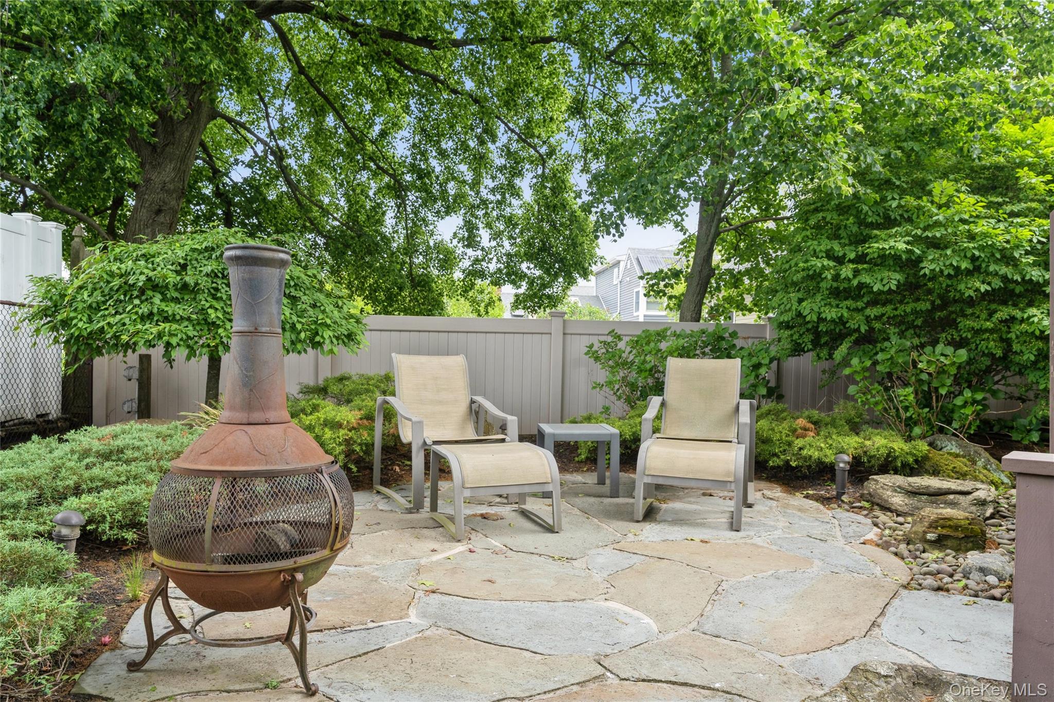 2772 Riverside Avenue Merrick, NY 11566 - Photo 29 of 45 a table and chairs in the patio