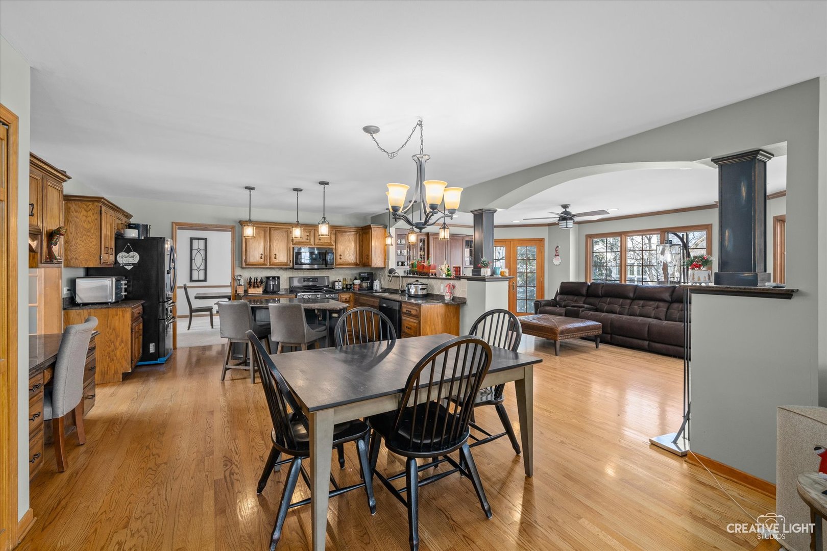 1135 Conan Doyle Road Naperville, IL 60564 - Photo 11 of 47 a view of a dining room and livingroom with furniture wooden floor a chandelier