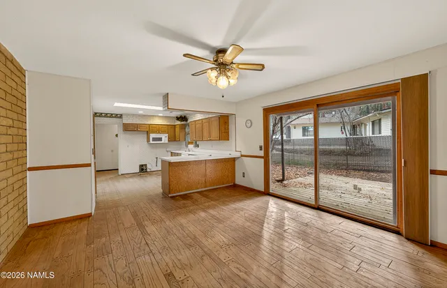 a view of a kitchen with a sink and a refrigerator
