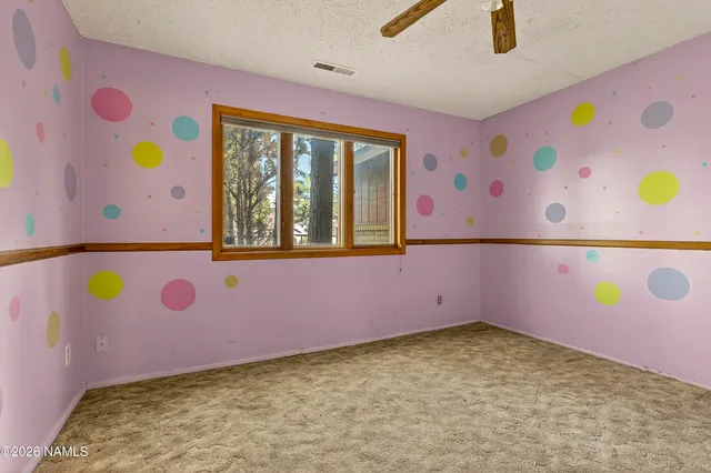 a bedroom with a bed and a refrigerator