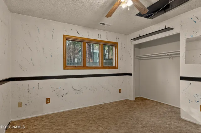 a view of storage and utility room with closet