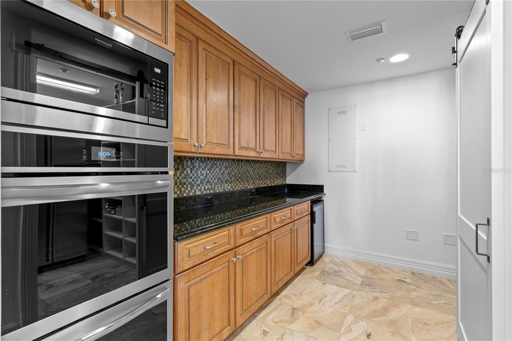 19730 Gulf Boulevard, Unit 400 Indian Rocks Beach, FL 33785 - Photo 36 of 90 a kitchen with granite countertop a stove microwave and sink