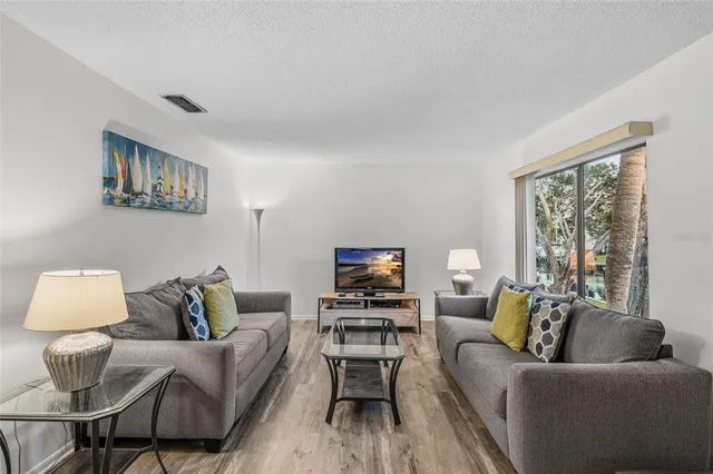 a view of a balcony with chairs and wooden fence